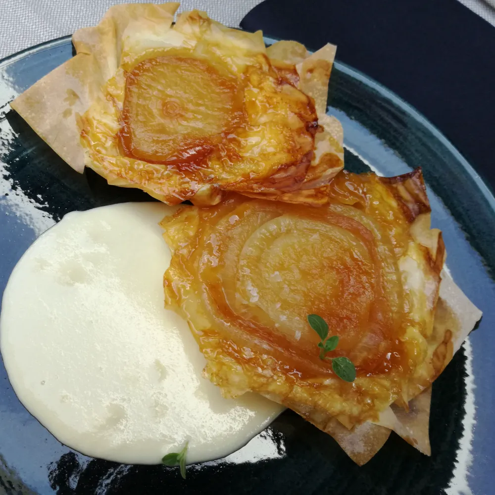 Baked onion with brown sugar and 24-month Parmigiano Reggiano cream, a signature dish at Osteria d'Asti in Arona.
