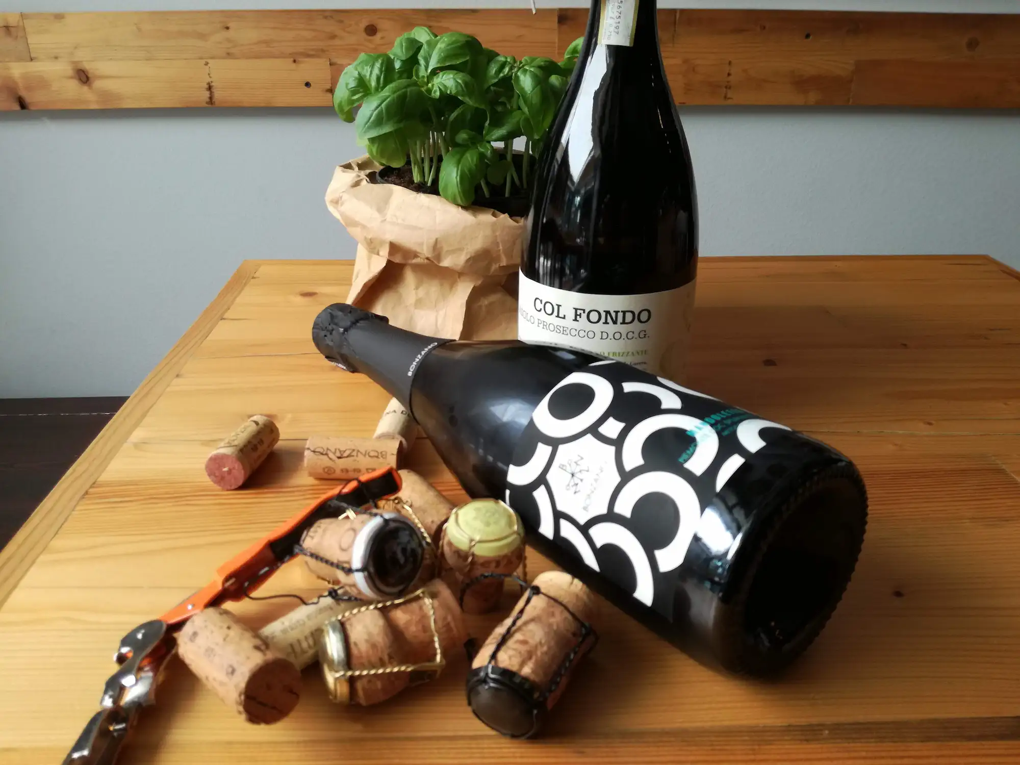 Wine bottles on a rustic wooden table at the Osteria d'Asti in Arona on Lake Maggiore